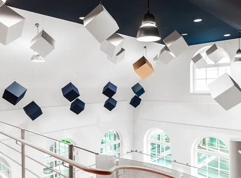 Akustikwürfel in Blau, Weiß und Gold über der Galerie des Saals