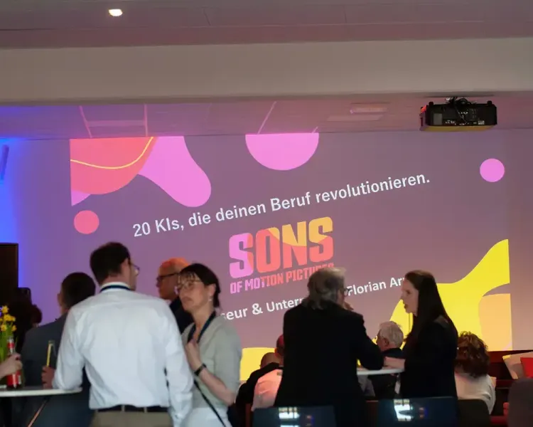 Publikum vor der Projektion „20 KIs, die deinen Beruf revolutionieren“